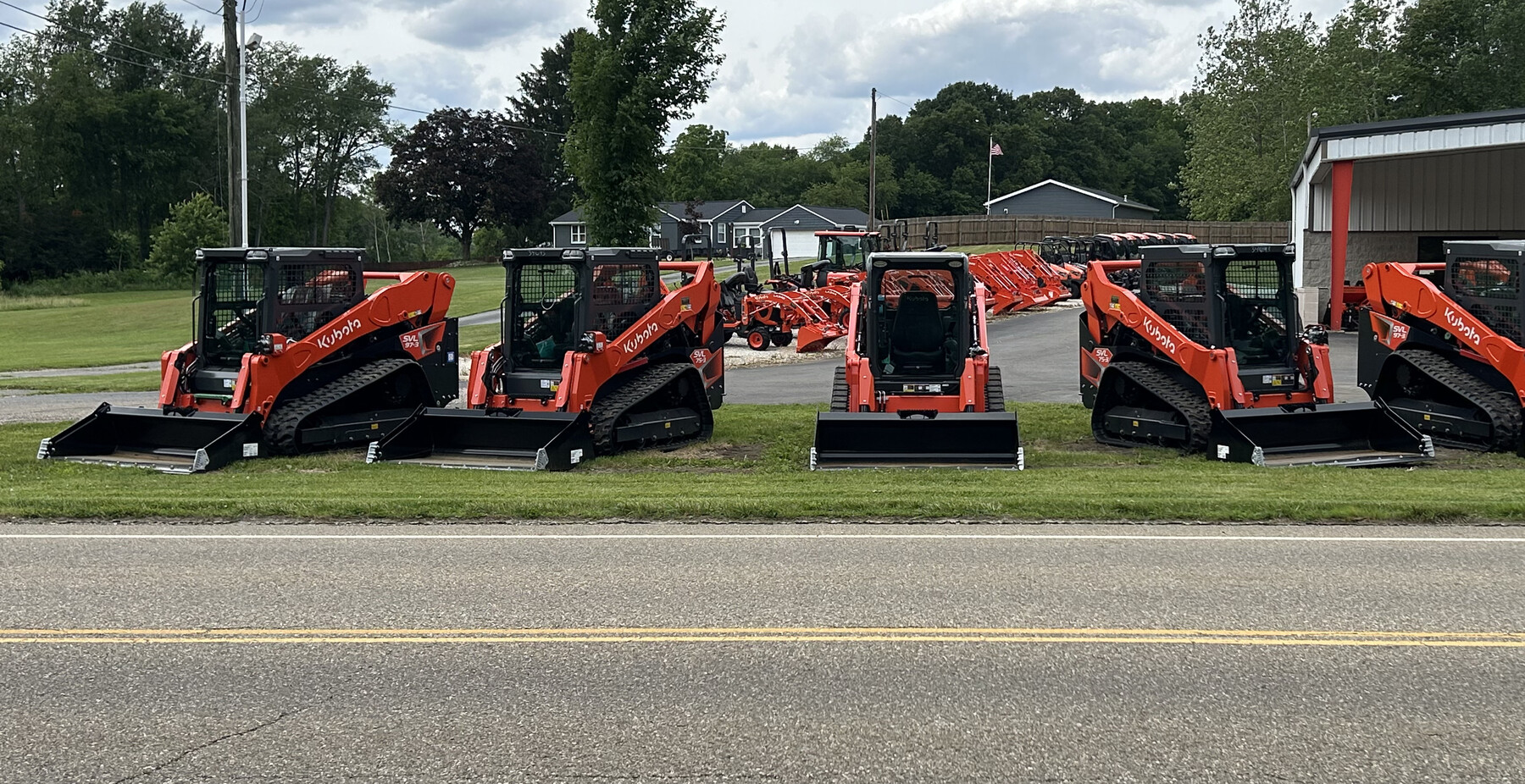 A lineup of Kubota SVL track loaders outside the Unkefer Sales dealership