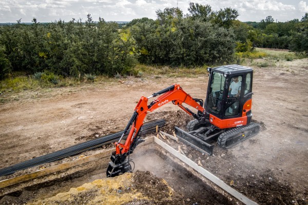 Kubota compact track loader parked in an autumn setting, ready for rental