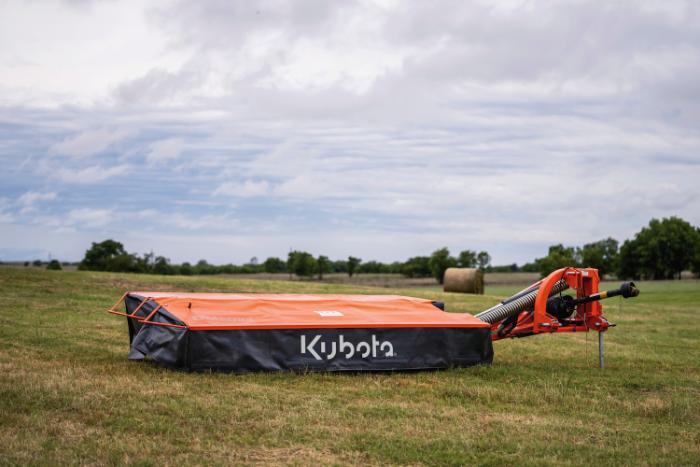 Kubota DM2032 disc mower cutting hay in a field