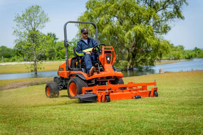 Kubota F2510 front-mount mower cutting grass beside a pond