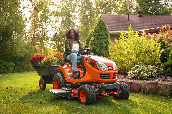 Kubota GR Series lawn tractor pulling a cart of flowers in a backyard