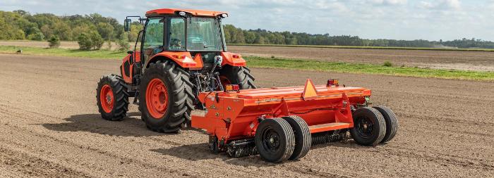 Kubota M5 Series cab tractor pulling a field implement