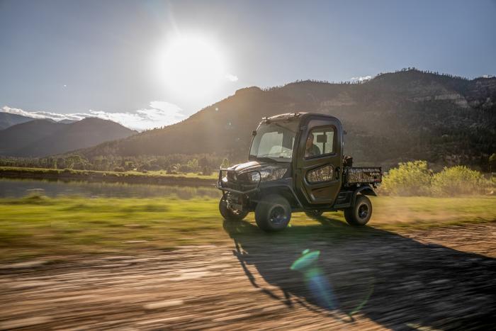 Kubota RTV-X2 Cab diesel utility vehicle driving with its factory cab enclosed