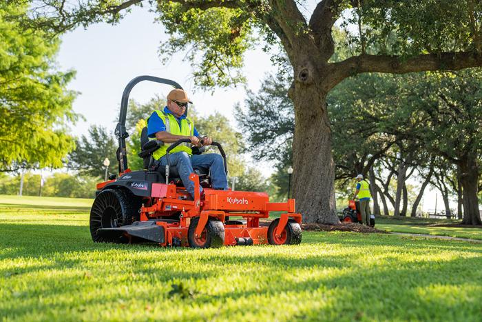 Kubota Z700 Series zero-turn mower cutting grass under trees